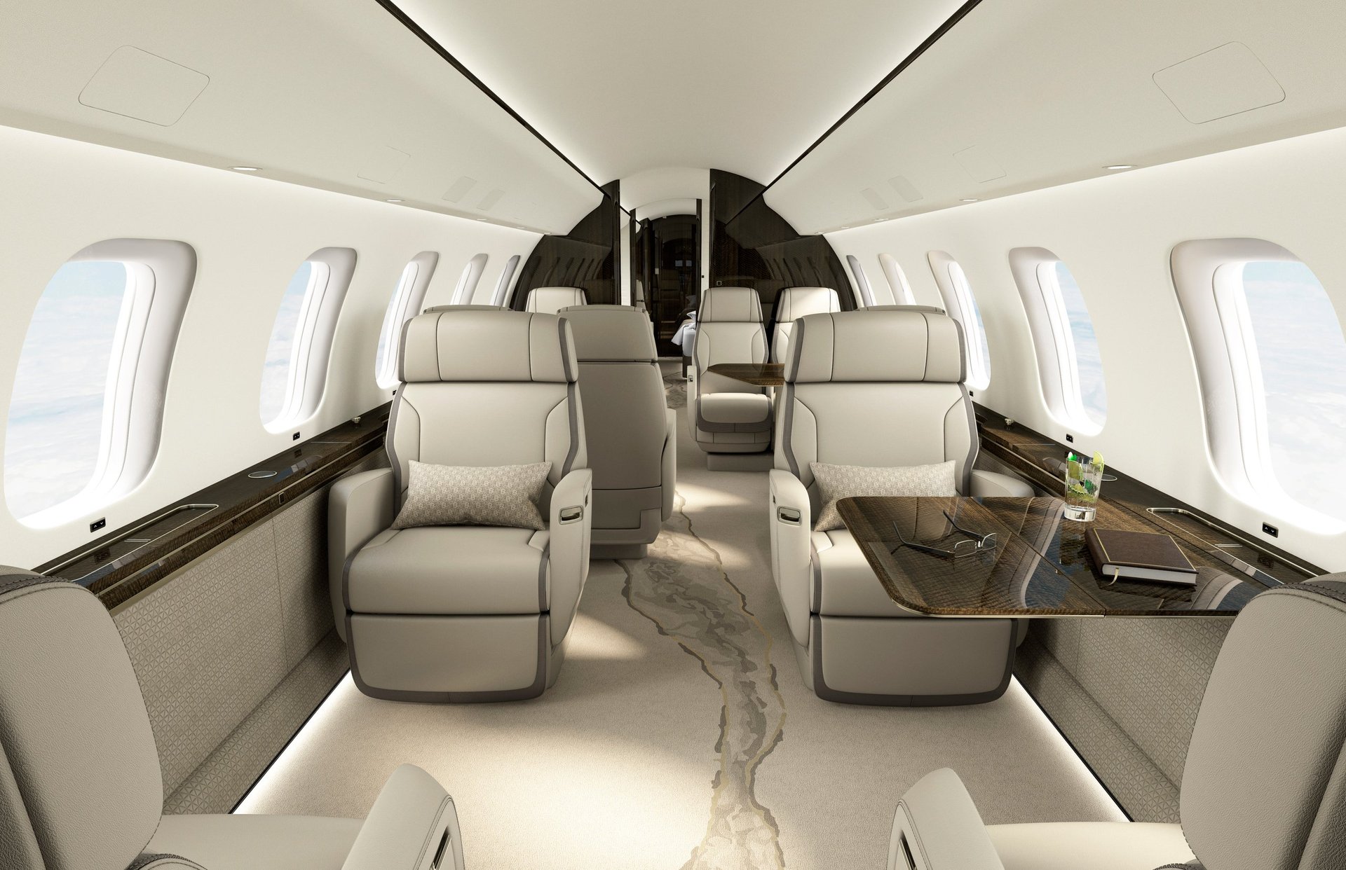 Interior of luxury private jet with cream-colored leather seats, polished flooring, and windows along cabin sides