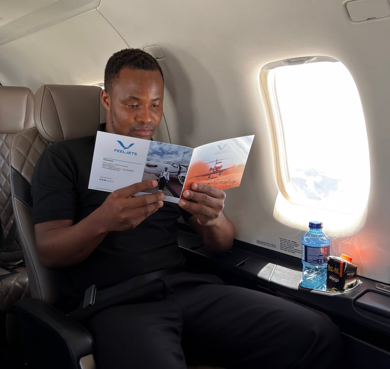 Man reading airline magazine in airplane seat by window with water bottle on tray table