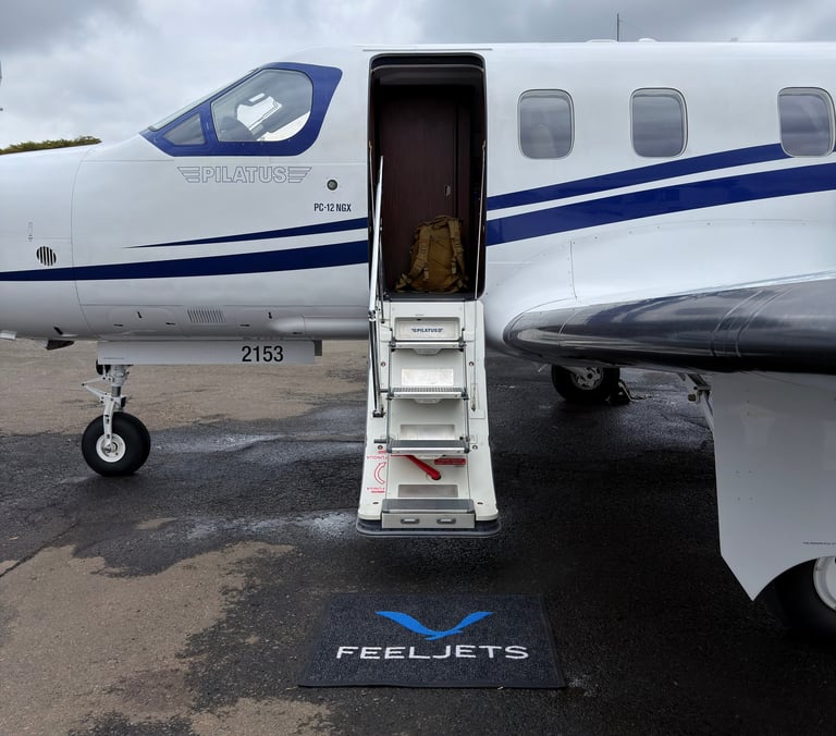 A FeelJets private aircraft with open door and boarding stairs on a tarmac